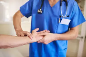 Shot of a young doctor monitoring his senior patient's pulse in the hospital